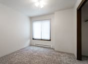 Thumbnail 44 of 57 - A room with a window and a carpeted floor. at Bristol Ridge, Iowa, 50322