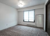 Thumbnail 30 of 57 - A room with a carpeted floor and a window with blinds. at Bristol Ridge, Urbandale, IA