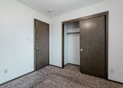 Thumbnail 6 of 57 - A room with two doors and a carpeted floor. at Bristol Ridge, Urbandale, IA, 50322