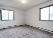 Thumbnail 7 of 57 - A room with a carpeted floor and two windows. at Bristol Ridge, Urbandale