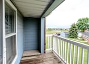 Thumbnail 25 of 33 - a balcony with a view of a yard and a house at Creekstone Falls, Sioux Falls, SD