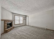 Thumbnail 20 of 33 - an empty living room with a fireplace and a window at Creekstone Falls, South Dakota, 57106