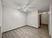 Thumbnail 33 of 33 - the spacious living room with a ceiling fan and wood flooring at Creekstone Falls, Sioux Falls, SD