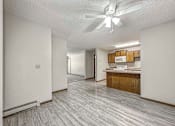 Thumbnail 21 of 33 - a view of a kitchen and living room with a geometric tile floor at Creekstone Falls, Sioux Falls, SD