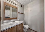 Thumbnail 22 of 33 - a bathroom with a toilet sink and a mirror at Creekstone Falls, South Dakota, 57106