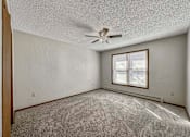 Thumbnail 17 of 33 - an empty living room with a ceiling fan and a window at Creekstone Falls, South Dakota, 57106