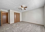 Thumbnail 23 of 33 - an empty living room with a ceiling fan at Creekstone Falls, Sioux Falls, SD