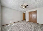 Thumbnail 28 of 33 - an empty living room with a ceiling fan at Creekstone Falls, Sioux Falls, SD, 57106