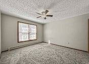 Thumbnail 27 of 33 - an empty living room with a ceiling fan and a window at Creekstone Falls, South Dakota, 57106