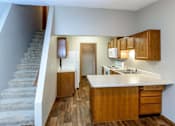 Thumbnail 26 of 33 - a kitchen with a sink and a refrigerator next to stairs at Creekstone Falls, Sioux Falls, SD, 57106