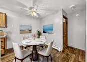 Thumbnail 4 of 33 - a dining room with a table and chairs and a ceiling fan at Creekstone Falls, Sioux Falls