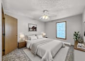 Thumbnail 5 of 33 - a bedroom with a bed and a ceiling fan at Creekstone Falls, Sioux Falls