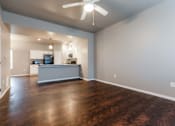 Thumbnail 1 of 30 - A spacious kitchen with a ceiling fan and wooden floors. at Danamere Village, Iowa, 50047