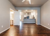 Thumbnail 17 of 30 - A spacious kitchen and living room with hardwood floors and a ceiling fan. at Danamere Village, Carlisle, 50047