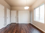 Thumbnail 24 of 30 - A room with wooden floors and white walls. at Danamere Village, Iowa, 50047