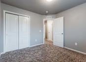 Thumbnail 2 of 30 - A room with white doors and carpeted floor. at Danamere Village, Carlisle, 50047