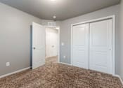 Thumbnail 13 of 30 - A room with white doors and carpeted floor. at Danamere Village, Iowa, 50047