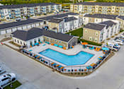 Thumbnail 38 of 42 - an aerial view of a swimming pool in an apartment complex  at Forge65, Pleasant Hill, IA, 50327