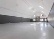 Thumbnail 42 of 66 - A long, empty hallway with a white ceiling and walls.