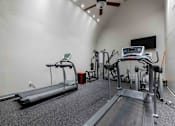 Thumbnail 45 of 66 - A treadmill and a rowing machine are in a well lit gym.