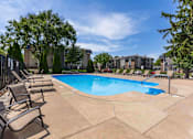 Thumbnail 63 of 66 - A pool surrounded by chairs and trees.