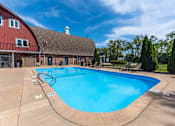 Thumbnail 36 of 66 - A large outdoor swimming pool with a red barn in the background.