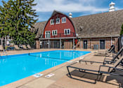 Thumbnail 33 of 66 - A large swimming pool in front of a red barn.