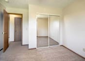 Thumbnail 15 of 24 - A room with a sliding door and a brown door at Hunters Run Apartments, IA, 50208