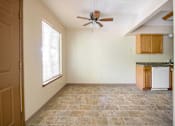 Thumbnail 5 of 24 - A room with a ceiling fan and a washing machine at Hunters Run Apartments, Newton, IA