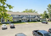 Thumbnail 20 of 24 - A building with a parking lot in front of it at Hunters Run Apartments, IA, 50208