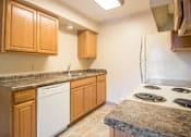 Thumbnail 9 of 24 - Kitchen with Brown cabinets at Hunters Run Apartments, Newton