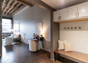 Thumbnail 2 of 99 - A room with a table, chairs, and a bench.at Plant 1 Lofts, N. Newton, IA 50208  