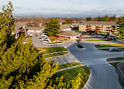 Thumbnail 75 of 90 - A parking lot with cars and a building in the background. at Rosemont Place Apartments, Des Moines, IA