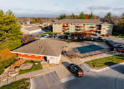 Thumbnail 73 of 90 - A car is parked in a parking lot in front of a building. at Rosemont Place Apartments, Des Moines, 50320