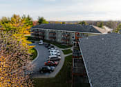 Thumbnail 68 of 90 - A parking lot with cars and a building in the background. at Rosemont Place Apartments, Des Moines, 50320