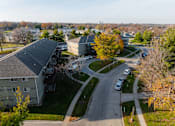Thumbnail 69 of 90 - A road with cars and apartment buildings at Rosemont Place Apartments, Des Moines, IA, 50320