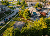 Thumbnail 65 of 90 - A basketball court is surrounded by trees and a parking lot. at Rosemont Place Apartments, Iowa