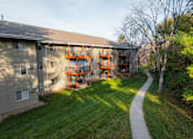 Thumbnail 58 of 90 - A building with a balcony and a walkway in front of it at Rosemont Place Apartments, Des Moines