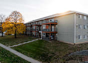 Thumbnail 50 of 90 - A building with a balcony and a tree with yellow leaves at Rosemont Place Apartments, Iowa, 50320