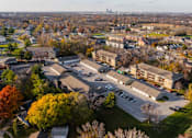 Thumbnail 82 of 90 - A large building complex with a parking lot in front of it at Rosemont Place Apartments, Des Moines, Iowa