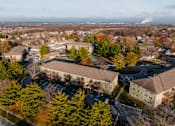 Thumbnail 52 of 90 - A large building surrounded by trees in the fall. at Rosemont Place Apartments, Des Moines, IA