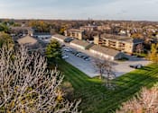 Thumbnail 85 of 90 - A parking lot is surrounded by apartment buildings at Rosemont Place Apartments, Des Moines, 50320