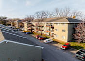 Thumbnail 83 of 90 - A parking lot with cars and apartment buildings in the background. at Rosemont Place Apartments, Iowa