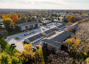 Thumbnail 77 of 90 - A large building complex surrounded by trees with autumn leaves. at Rosemont Place Apartments, Des Moines, IA, 50320