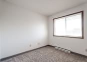 Thumbnail 37 of 90 - A room with a window and a radiator on the floor at Rosemont Place Apartments, Des Moines, 50320