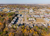 Thumbnail 38 of 42 - An aerial view of a small town with a large parking lot in the foreground. at Saylorville Lakeside, Polk City, IA