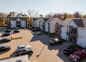 Thumbnail 33 of 42 - A parking lot with cars and apartment buildings in the background. at Saylorville Lakeside, Polk City, IA, 50226