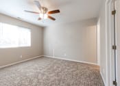 Thumbnail 2 of 42 - A room with a ceiling fan and a carpeted floor. at Saylorville Lakeside, Polk City, 50226