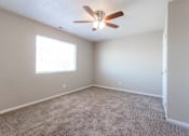 Thumbnail 7 of 42 - A room with a ceiling fan and carpeted floor. at Saylorville Lakeside, Polk City