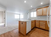 Thumbnail 11 of 42 - A kitchen with wooden cabinets and a white fridge. at Saylorville Lakeside, Polk City, Iowa